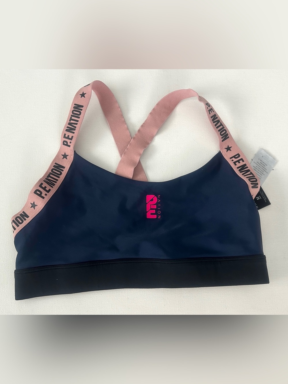 P.E Nation women’s Navy Sports Bra with Pink Straps and Logo.  Size M.